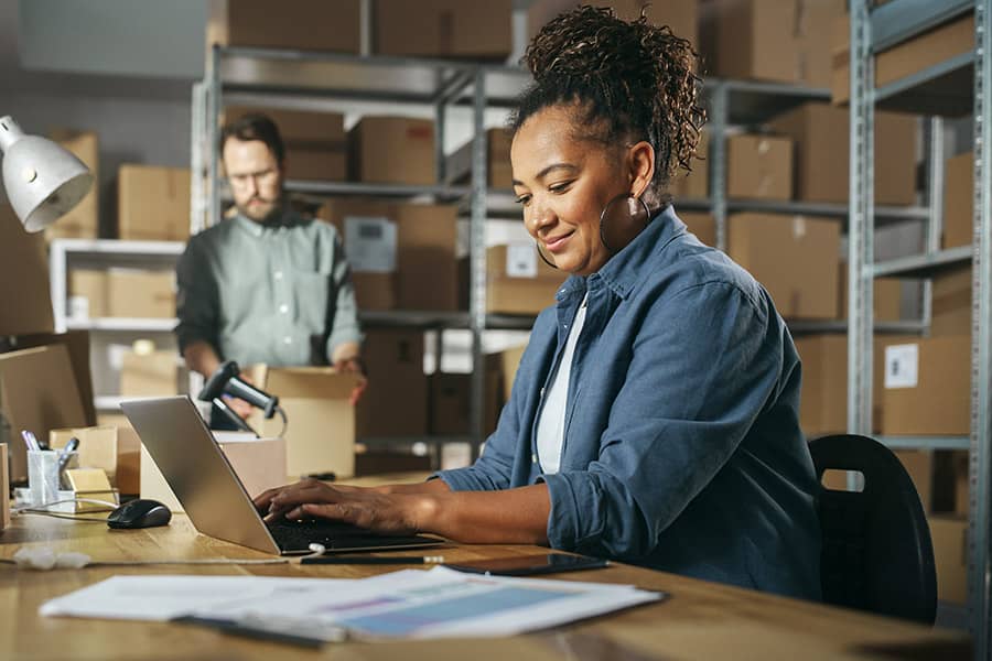 A woman works on inventory at her business
