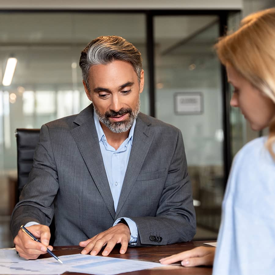 A lawyer filling out paperwork with a client