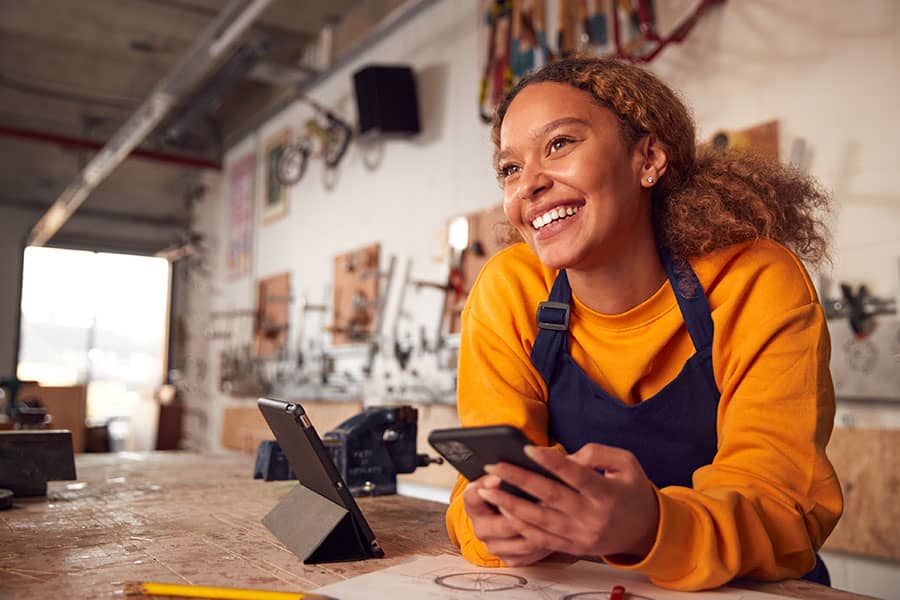A smiling woman in her workshop