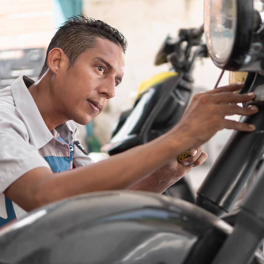 A mechanic working on a motorcycle