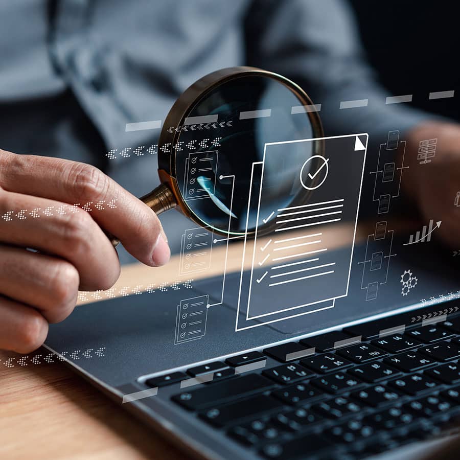 Concept of a hand with a magnifying glass inspecting files
