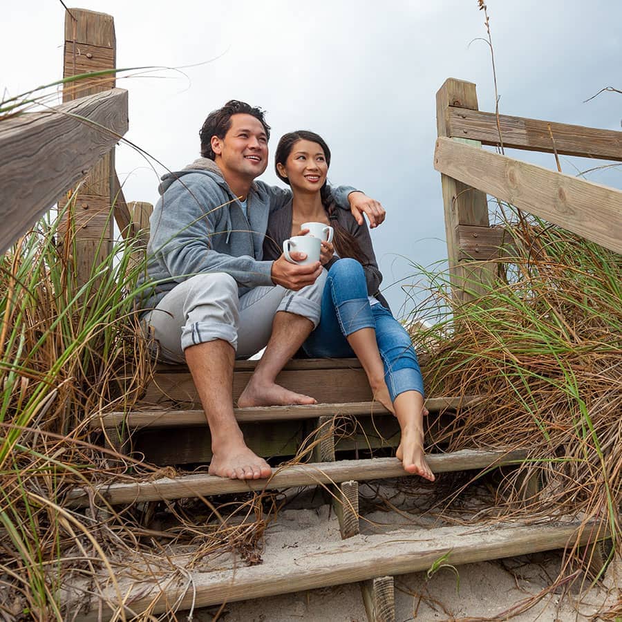 A couple sitting at the beach