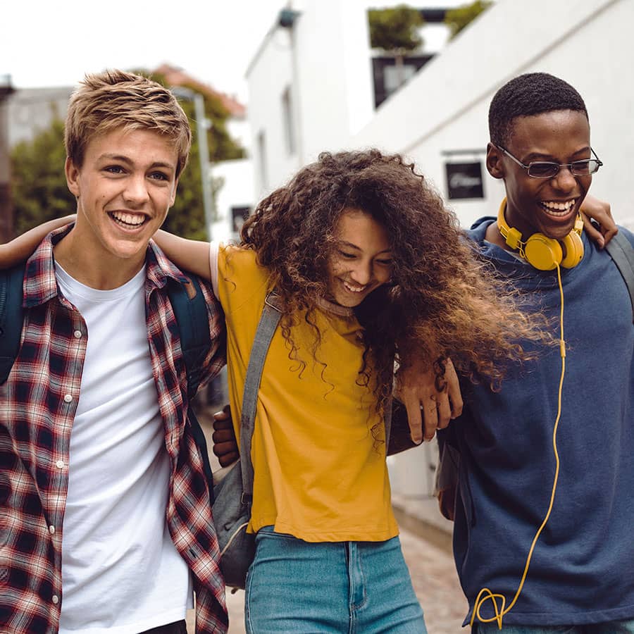 Three college students hugging