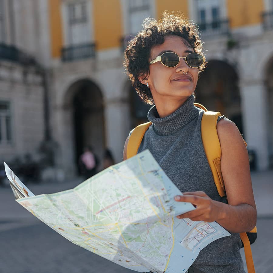 A woman looking at a map while traveling