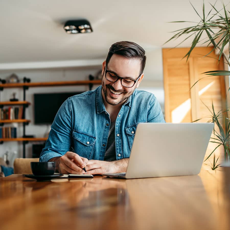 A man smiling while using Sunstate Bank online banking