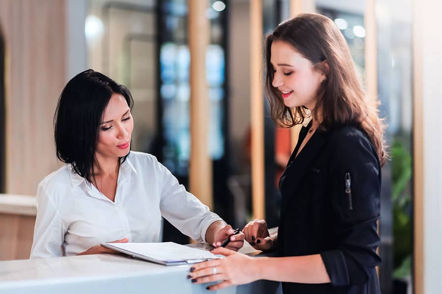 A bank teller facilitating a wire transfer for a customer